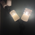 La Paire Appliques Verre 1960 est une applique murale vintage avec trois lampes givrées illuminées sur un fond sombre, apportant une élégance intemporelle à n'importe quel décor. Brocante 93